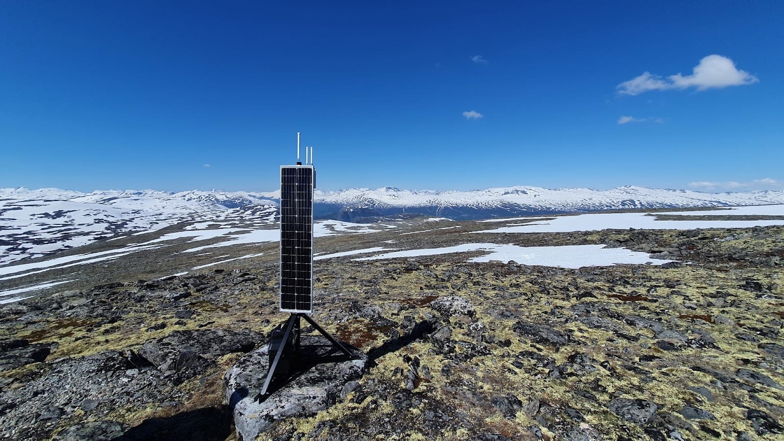 LoRaWAN scalability is about long-term operation and maintenance, illustrated by a solar-powered gateway in a remote landscape